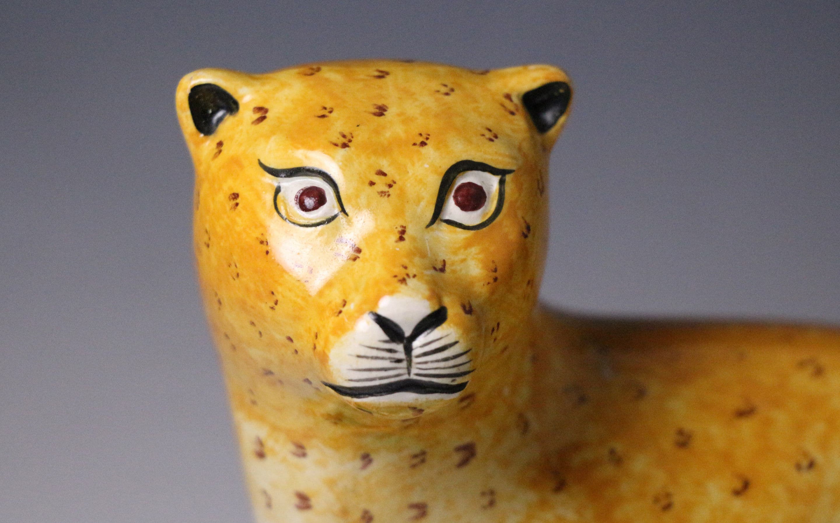 English pottery figure of a leopard on a green base creamware bodied ...