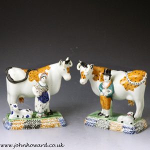 Pair of antique Yorkshire pottery prattware cows with attendants, Mexborough Pottery.