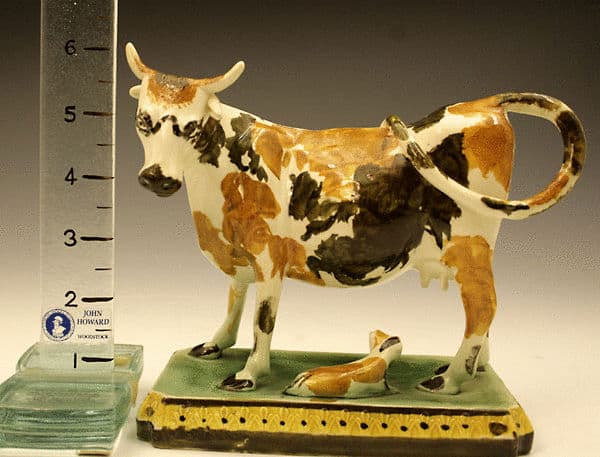 Prattware pottery figure of a cow and calf on base. - John Howard