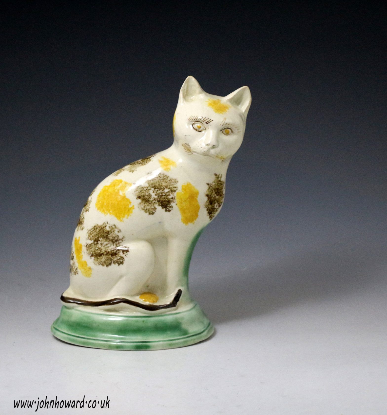 Antique English pottery figure of a seated cat with underglaze colours ...