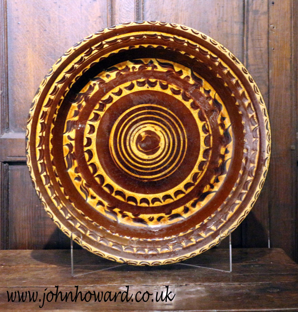 Antique English earthenware slipware circular dish with masterful ...