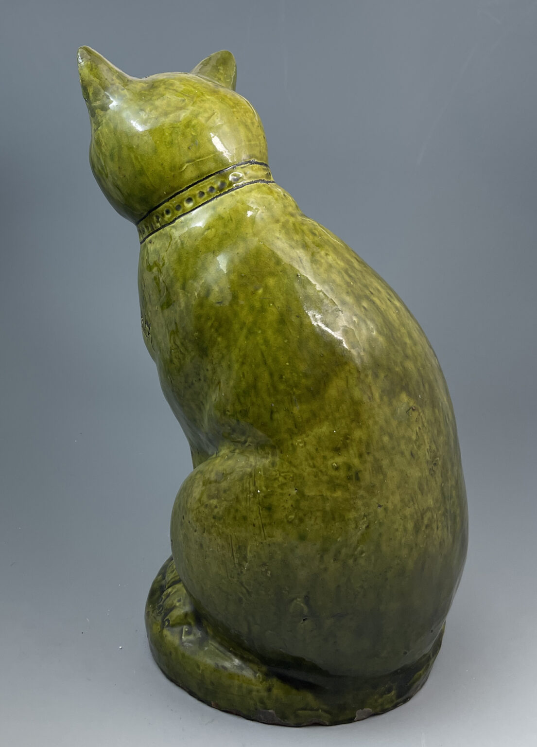 Green slip glazed figure of a seated cat from the Ewenny Pottery ...