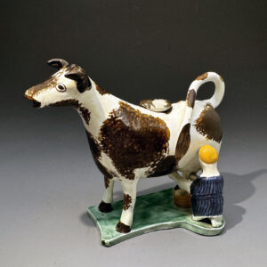 English pearlware pottery cow creamer with milk maid circa 1800