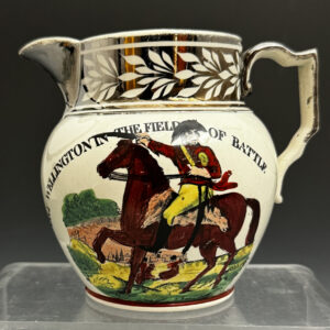 English pottery commemorative jug with silver lustre  rim  relating to Napoleon and Wellington early 19th century