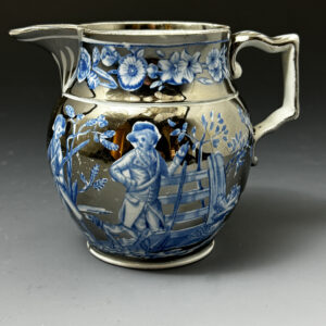 Silver lustre pottery pitcher with underglaze blue decoration of rural sporting figures. c1815